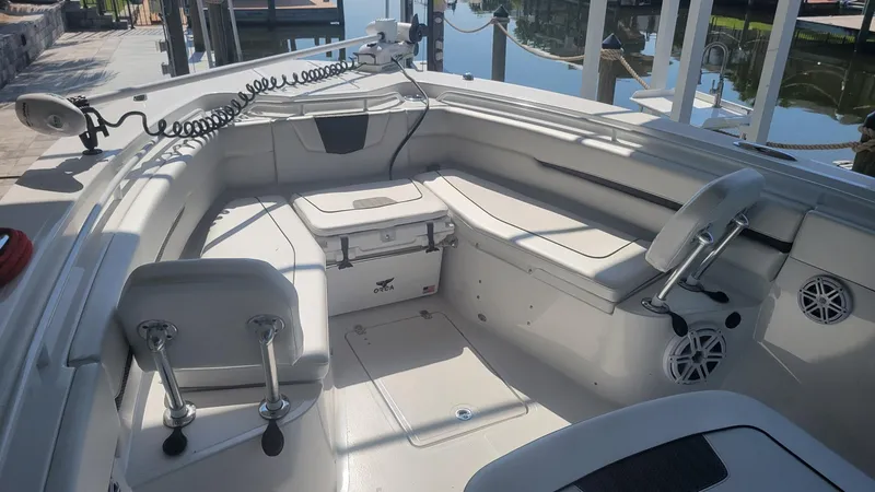 Slide: The Image of 2023 Wellcraft 352 Fisherman boat interior with seating and storage, docked by the water. - 3