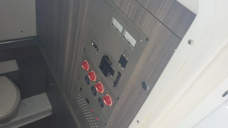 Slide: The Image of Control panel inside 2023 Wellcraft 352 Fisherman boat, featuring switches and gauges. - 33