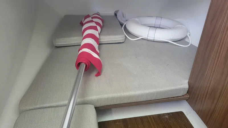 Slide: The Image of Interior of 2023 Wellcraft 352 Fisherman with cushions, life ring, and striped flag. - 35