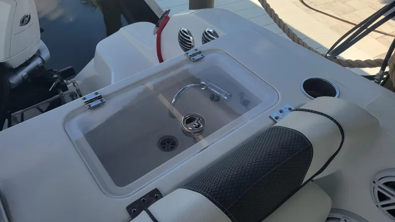 Slide: The Image of 2023 Wellcraft 352 Fisherman boat sink and seating area. - 38