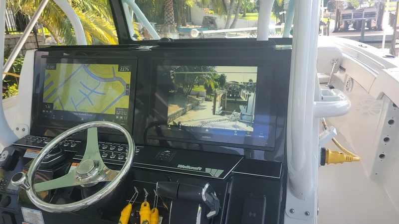 Slide: The Image of 2023 Wellcraft 352 Fisherman dashboard with navigation and control screens. - 5