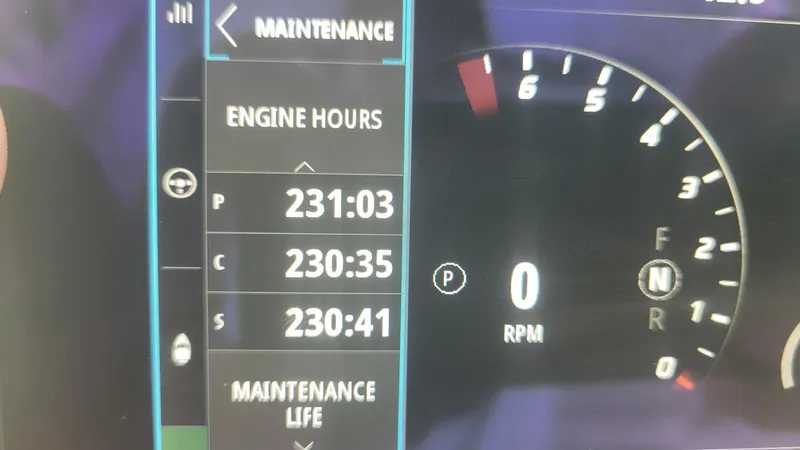 Slide: The Image of 2023 Wellcraft 352 Fisherman dashboard showing engine hours and RPM gauge. - 7