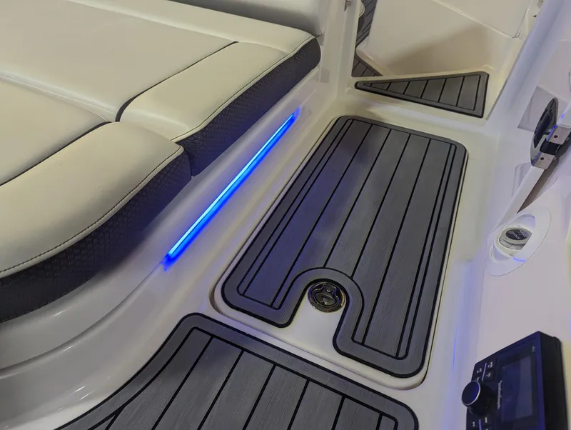 Slide: The Image of 2017 Sea Ray SDX 270 interior with blue LED lighting and cushioned seating. - 10