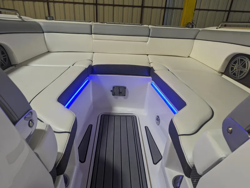 Slide: The Image of 2017 Sea Ray SDX 270 boat interior with blue LED lighting and cushioned seating. - 14