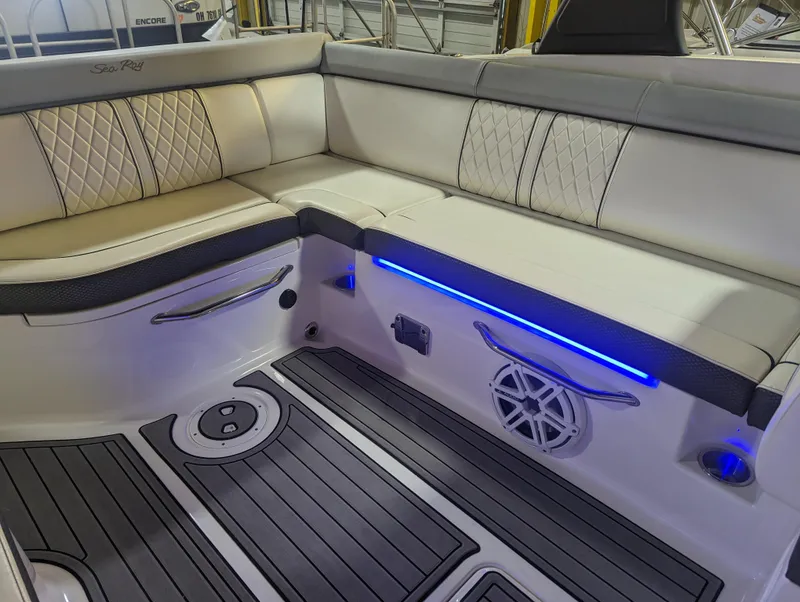 Slide: The Image of 2017 Sea Ray SDX 270 boat interior with cushioned seating and blue LED lighting. - 19