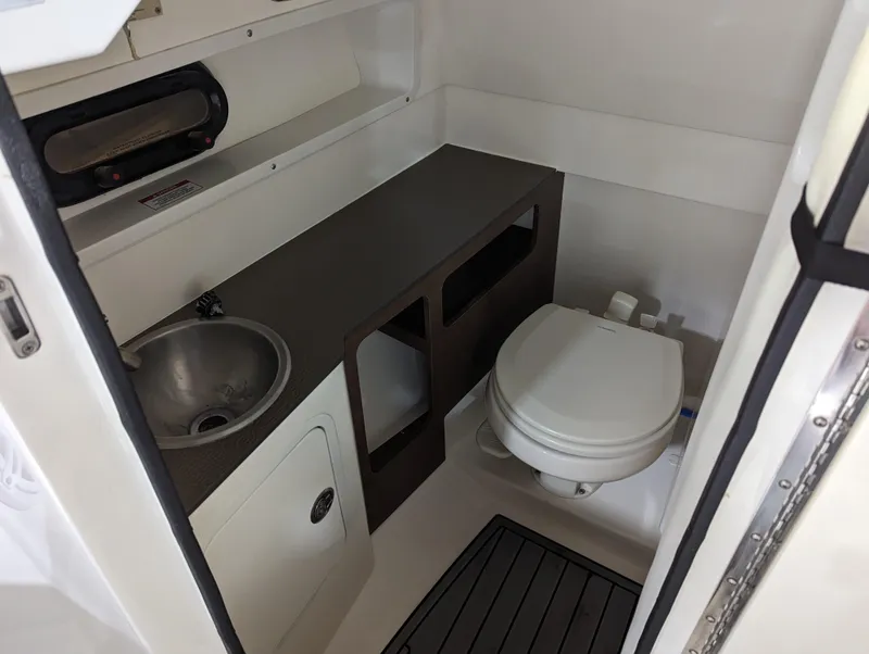Slide: The Image of 2017 Sea Ray SDX 270 boat bathroom with sink and toilet. - 20