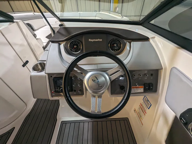 Slide: The Image of Steering wheel and dashboard of 2017 Sea Ray SDX 270 boat, featuring Raymarine electronics. - 25