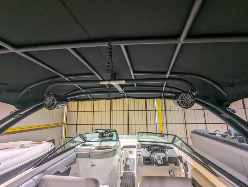 Slide: The Image of 2017 Sea Ray SDX 270 boat interior with black canopy and modern dashboard. - 27