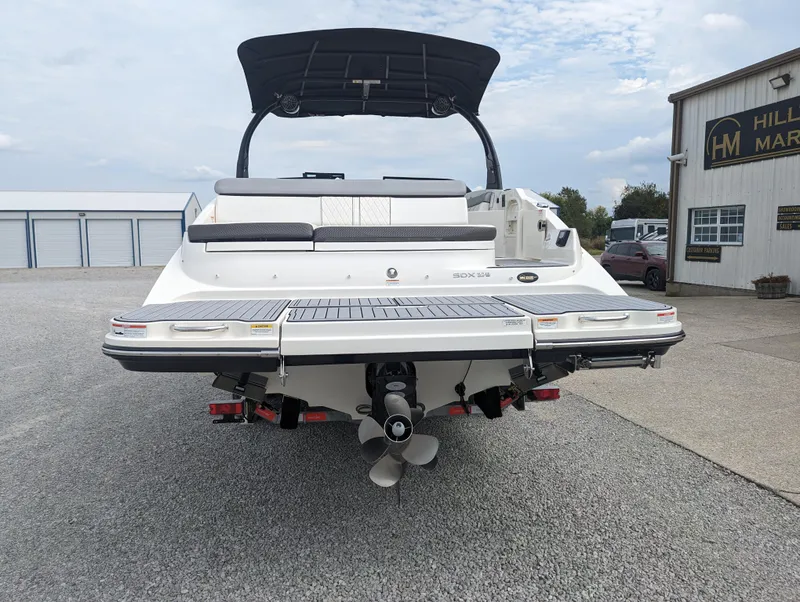 Slide: The Image of 2017 Sea Ray SDX 270 boat, rear view, parked outdoors near a building. - 3
