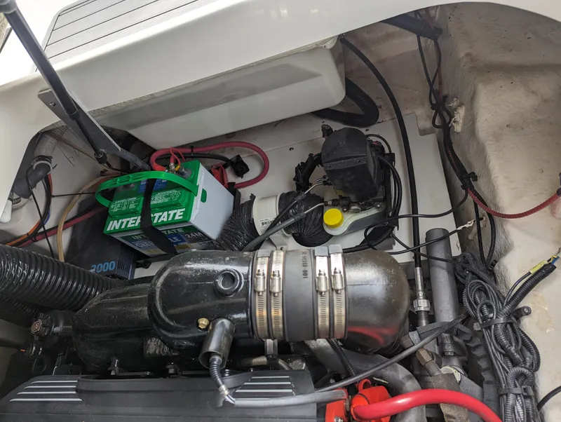 Slide: The Image of Engine compartment of a 2017 Sea Ray SDX 270 boat, featuring battery and wiring. - 32