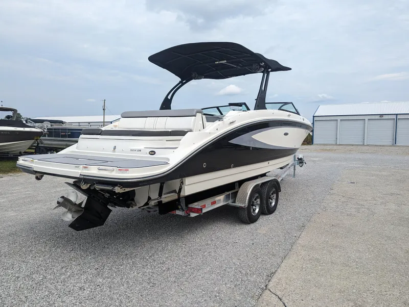 Slide: The Image of 2017 Sea Ray SDX 270 boat on trailer, parked outdoors, with a black canopy. - 4