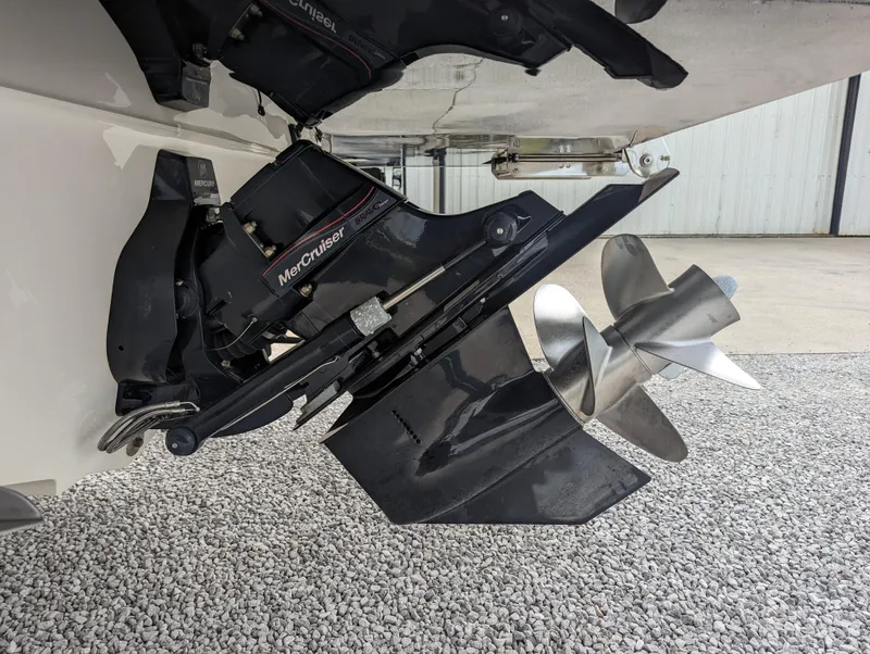 Slide: The Image of 2017 Sea Ray SDX 270 boat with MerCruiser outdrive and propeller on gravel surface. - 7