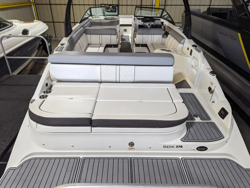 Slide: The Image of 2017 Sea Ray SDX 270 boat interior with spacious seating and modern design. - 8
