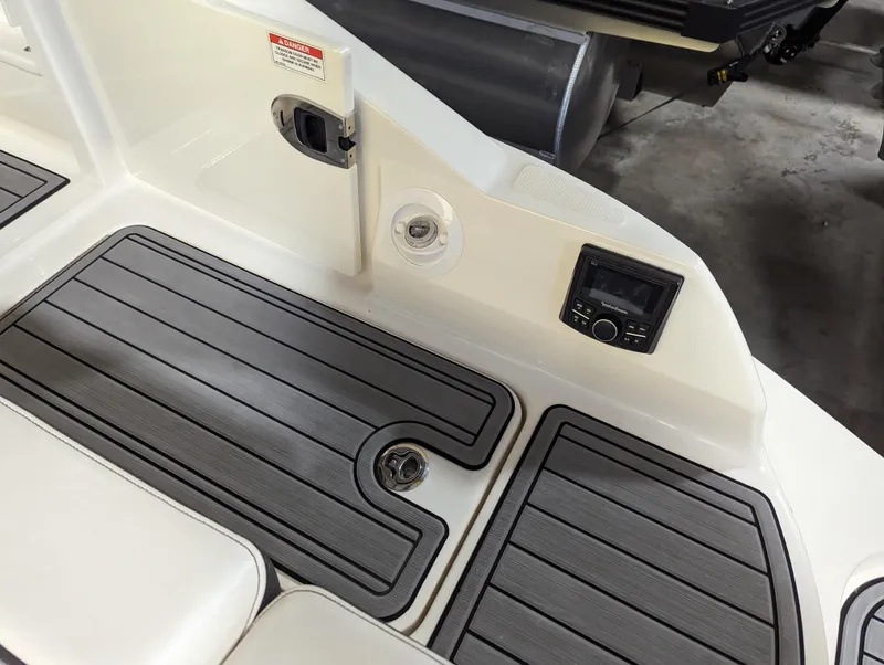 Slide: The Image of 2017 Sea Ray SDX 270 boat deck with non-slip flooring and control panel. - 9