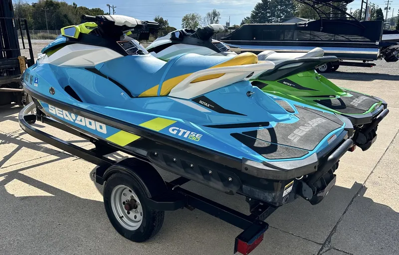 Slide: The Image of 2015 Sea-Doo GTI SE 130 jet ski on trailer, blue and yellow design. - 7