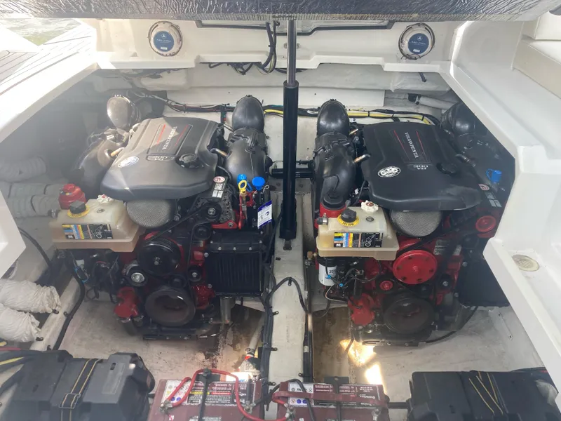 Slide: The Image of Engine compartment of 2019 Cruisers Yachts 338, featuring dual inboard motors and mechanical components. - 14