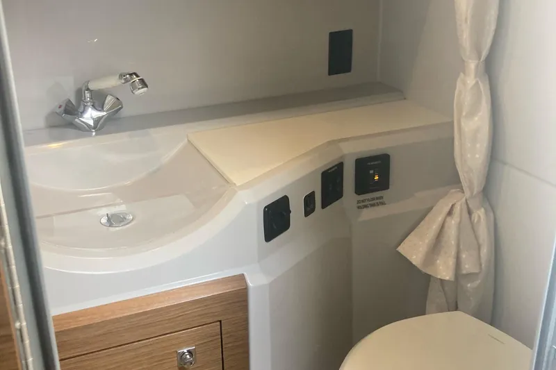 Slide: The Image of 2019 Cruisers Yachts 338 bathroom with sink, faucet, and storage cabinet. - 18