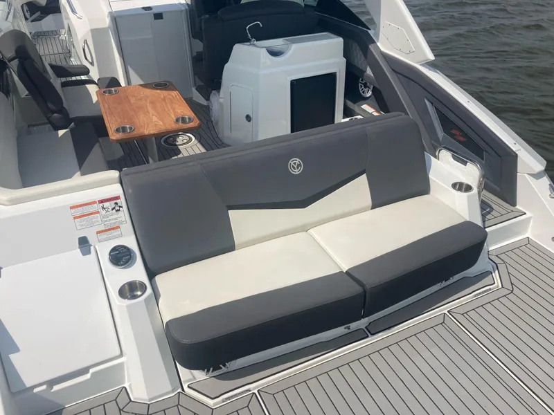 Slide: The Image of 2019 Cruisers Yachts 338 interior with seating, table, and water view. - 4