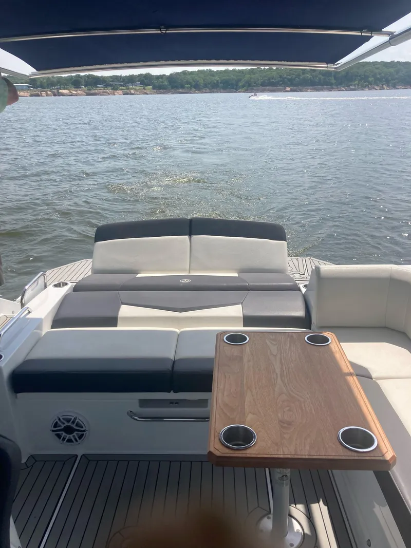 Slide: The Image of 2019 Cruisers Yachts 338 interior with seating and table, overlooking calm waters. - 5