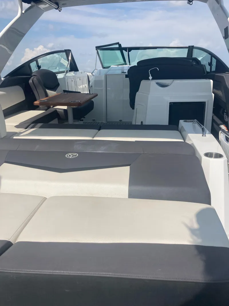Slide: The Image of 2019 Cruisers Yachts 338 interior with seating and table, showcasing luxury design. - 6