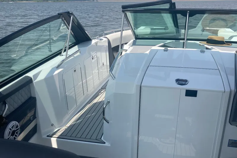 Slide: The Image of 2019 Cruisers Yachts 338 boat interior with sleek design and spacious deck on water. - 13