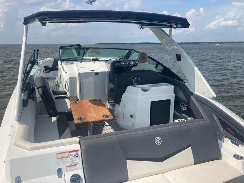 Slide: The Image of 2019 Cruisers Yachts 338 on open water, featuring spacious seating and modern design. - 3