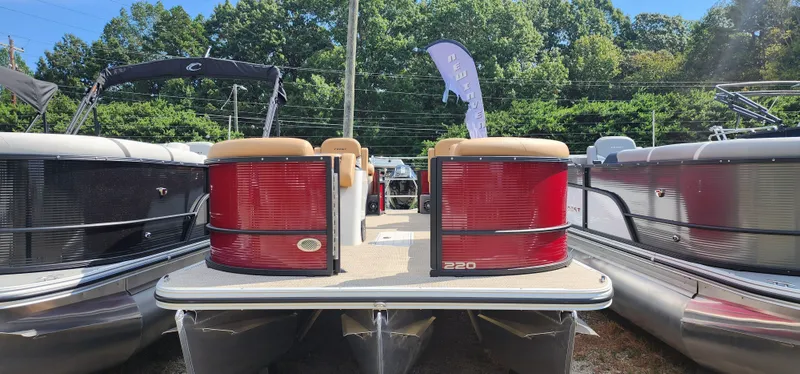 The Image of 2025 Crest CLASSIC 220 SLC pontoon boat displayed outdoors. - 1