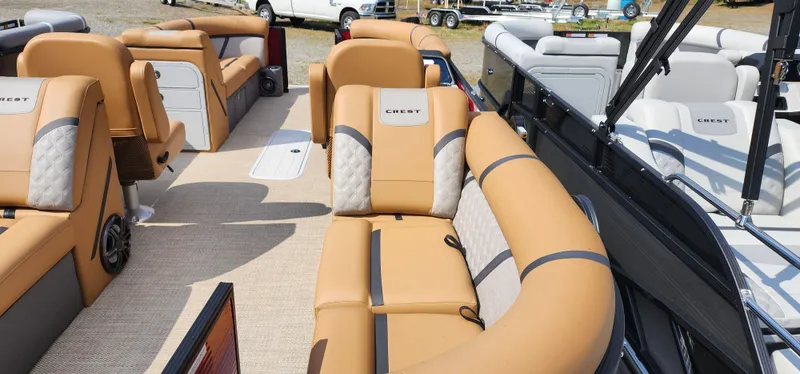Slide: The Image of 2025 Crest CLASSIC 220 SLC boat interior with tan seating and modern design. - 7