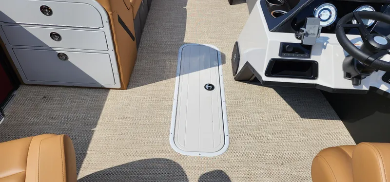 Slide: The Image of 2025 Crest CLASSIC 220 SLC boat interior with beige carpet and modern dashboard. - 8