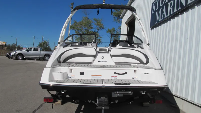 Slide: The Image of 2025 Yamaha Boats 195S, rear view at marina, showcasing sleek design and seating. - 3
