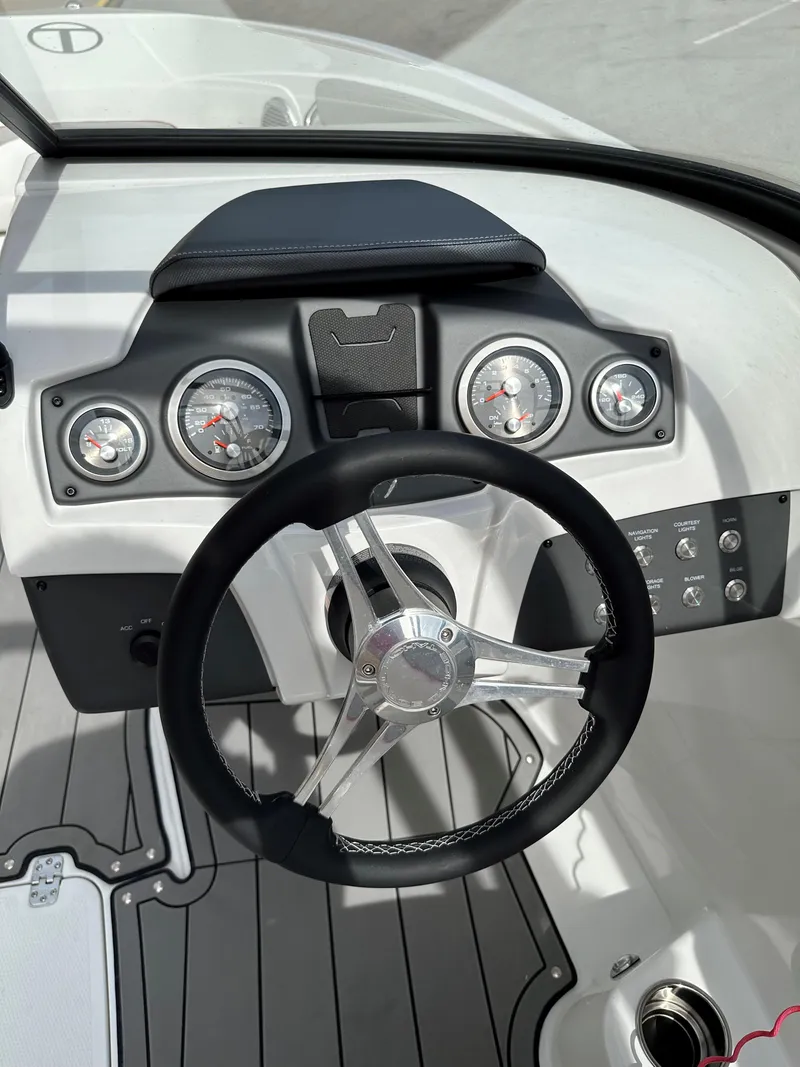 Slide: The Image of 2021 Tahoe 700 boat dashboard with steering wheel and gauges. - 10