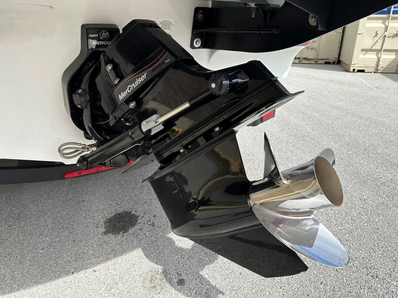 Slide: The Image of 2021 Tahoe 700 boat with MerCruiser outboard motor and propeller. - 4