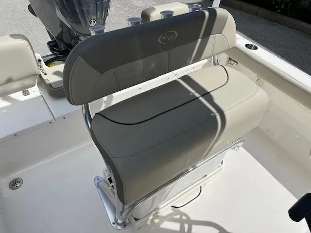 Slide: The Image of 2023 Key West 189 FS boat interior with cushioned seating and motor. - 4