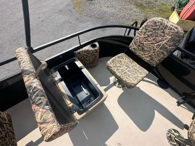 Slide: The Image of 2025 Starcraft LX 22 F boat interior with camo seats and storage compartment. - 4