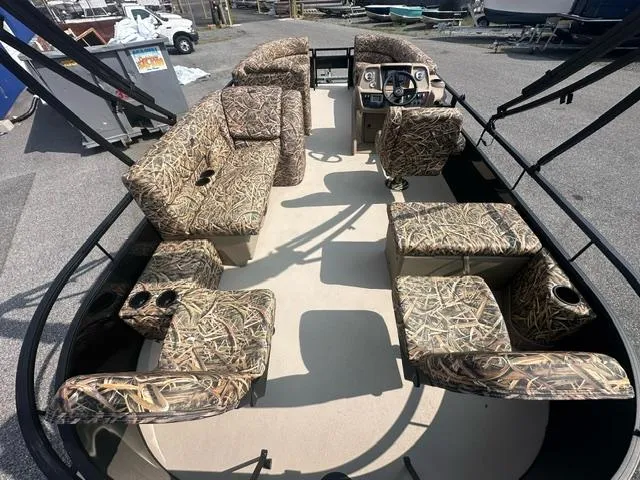 Slide: The Image of 2025 Starcraft LX 22 F pontoon boat with camouflage seating and spacious deck layout. - 3