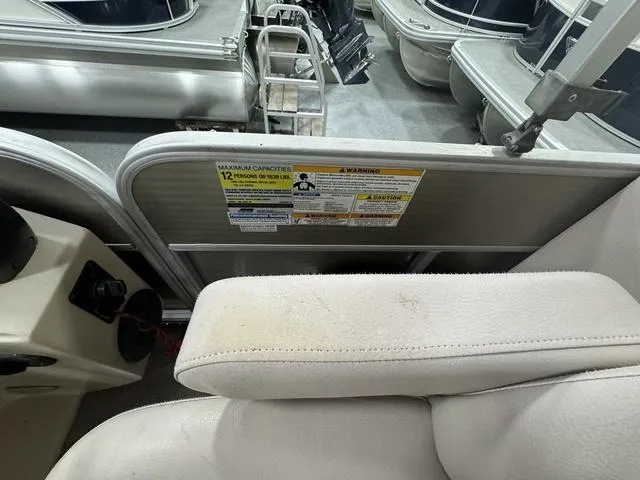 Slide: The Image of Interior of a 2014 Sweetwater SW 2286 SLC pontoon boat with seating and capacity warning label. - 11