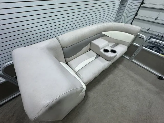 Slide: The Image of 2014 Sweetwater SW 2286 SLC boat seating with cup holders in a garage setting. - 14