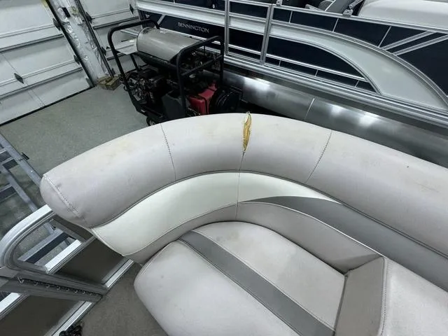 Slide: The Image of 2014 Sweetwater SW 2286 SLC pontoon boat with torn upholstery in a garage. - 16