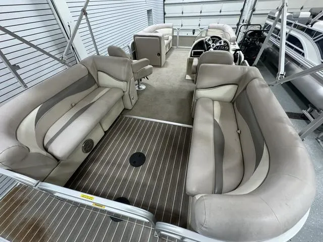 Slide: The Image of 2014 Sweetwater SW 2286 SLC pontoon boat interior with plush seating and steering console. - 6
