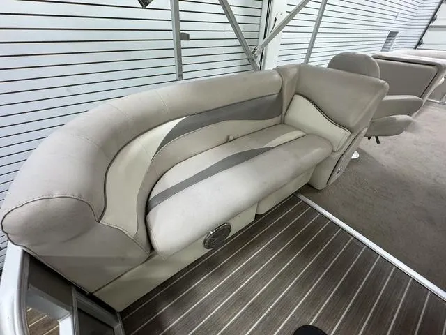 Slide: The Image of 2014 Sweetwater SW 2286 SLC boat interior with beige seating and striped flooring. - 7