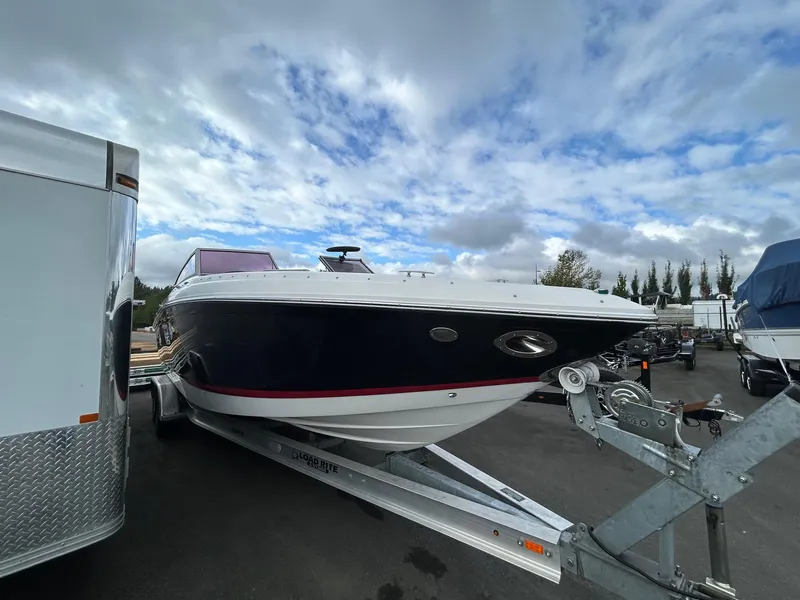 Slide: The Image of 2010 Cobalt 262 boat on trailer under cloudy sky. - 1