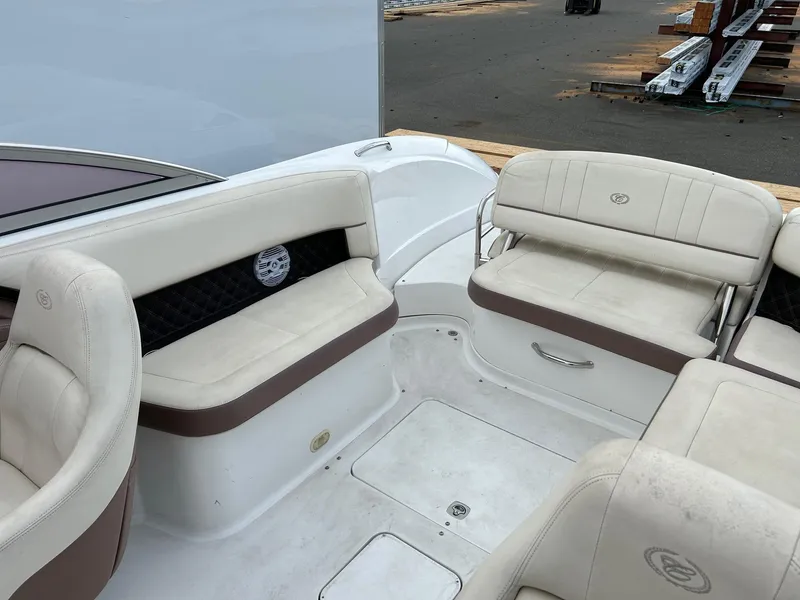 Slide: The Image of 2010 Cobalt 262 boat interior with beige seating and storage compartments. - 12