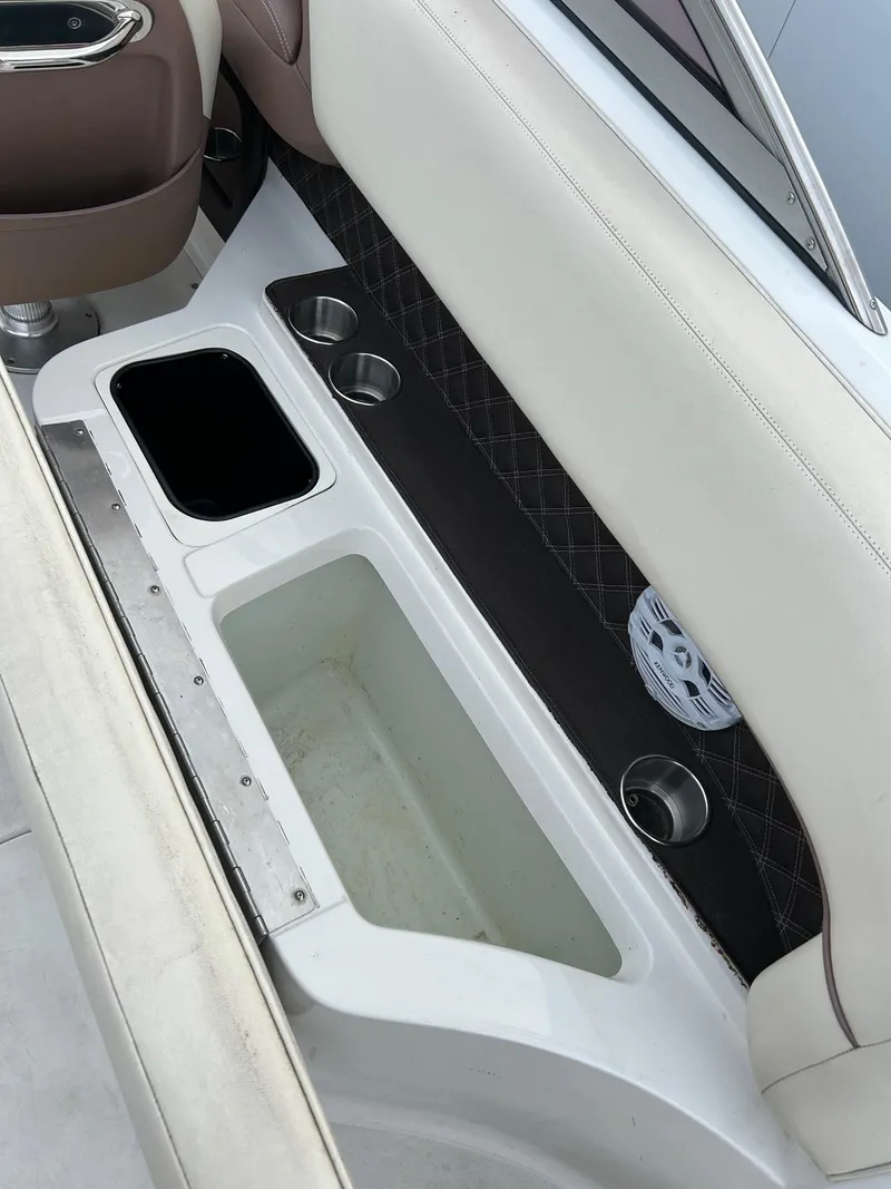 Slide: The Image of Interior of 2010 Cobalt 262 boat with cup holders and storage compartments. - 14