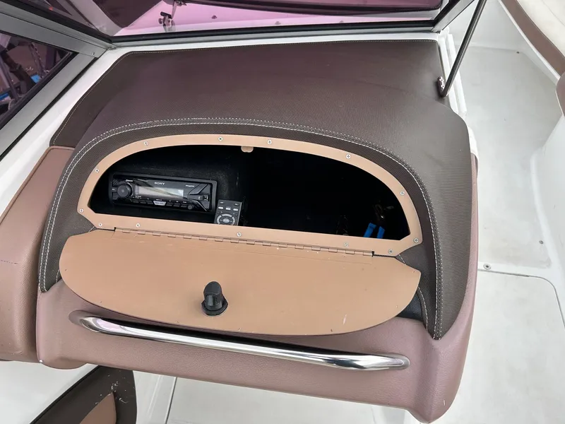 Slide: The Image of 2010 Cobalt 262 boat dashboard with open glove compartment and stereo system. - 15