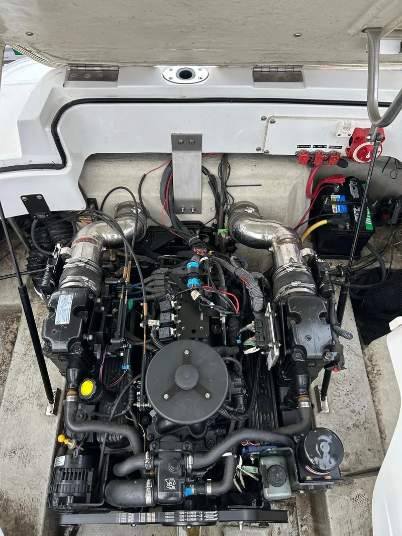 Slide: The Image of 2010 Cobalt 262 boat engine compartment with visible wiring and components. - 17