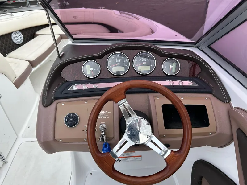 Slide: The Image of 2010 Cobalt 262 boat dashboard with wood steering wheel and instrument panel. - 4