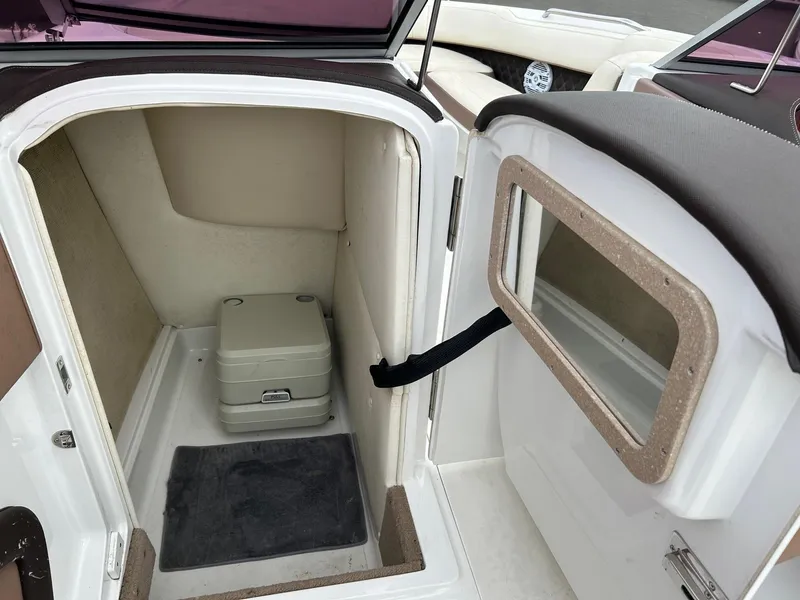 Slide: The Image of 2010 Cobalt 262 boat interior with compact toilet and storage area. - 5