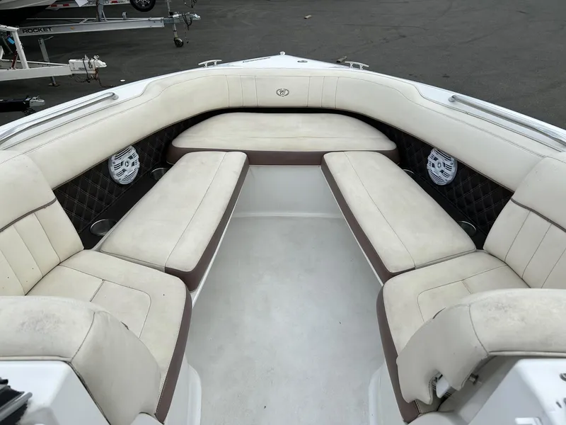 Slide: The Image of 2010 Cobalt 262 boat interior with white cushioned seating. - 7