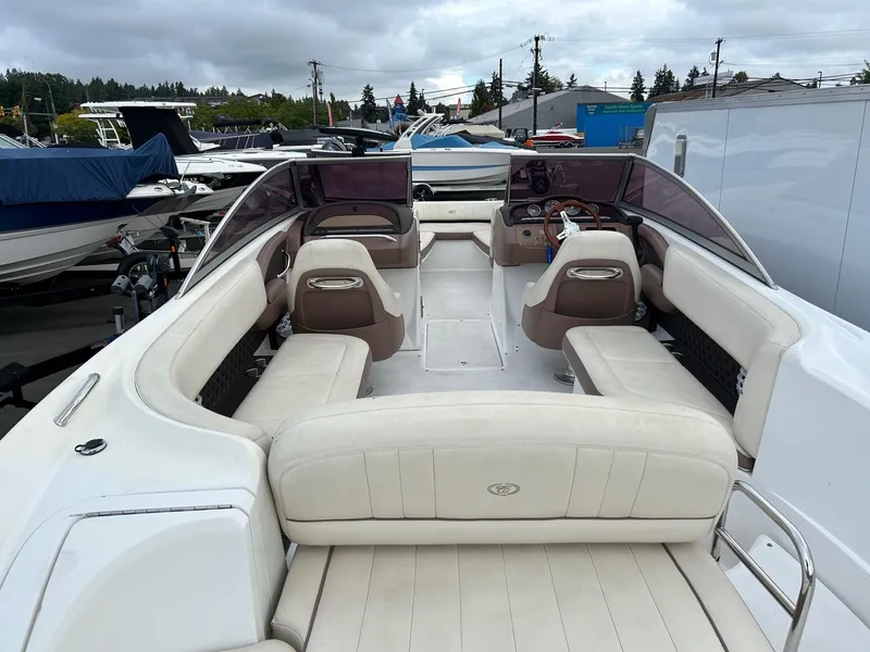 Slide: The Image of 2010 Cobalt 262 boat with spacious seating and sleek design, docked outdoors. - 8