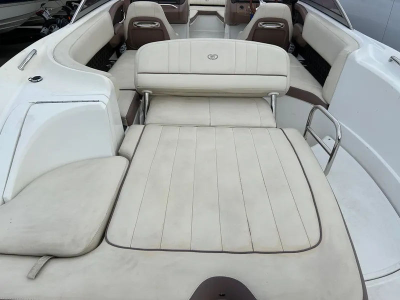 Slide: The Image of 2010 Cobalt 262 boat interior with beige seating and spacious layout. - 9